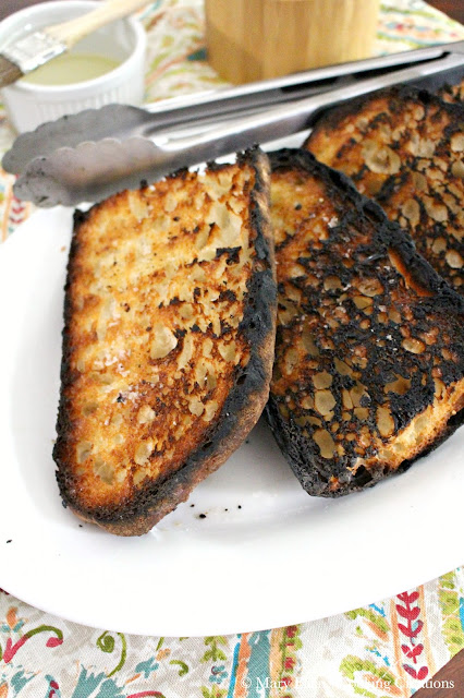 Cripsy, charred grilled bread for grilled bread salad with spinach, tomatoes and blue cheese. The perfect summer salad. Great for entertaining. #salad #grilledbread #panzanella