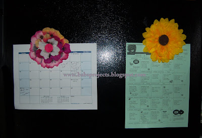 Floral Refrigerator Magnet Displayed on Calendar on a Black Refrigerator
