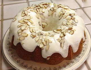 Eggnog Bundt Cake: A cake based on a yellow cake mix box mix that's made with eggnog and decorated with white icing and almonds for Christmas