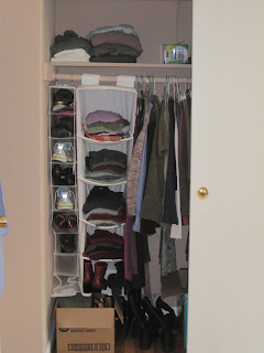Tidy closet with shoes and sweaters 