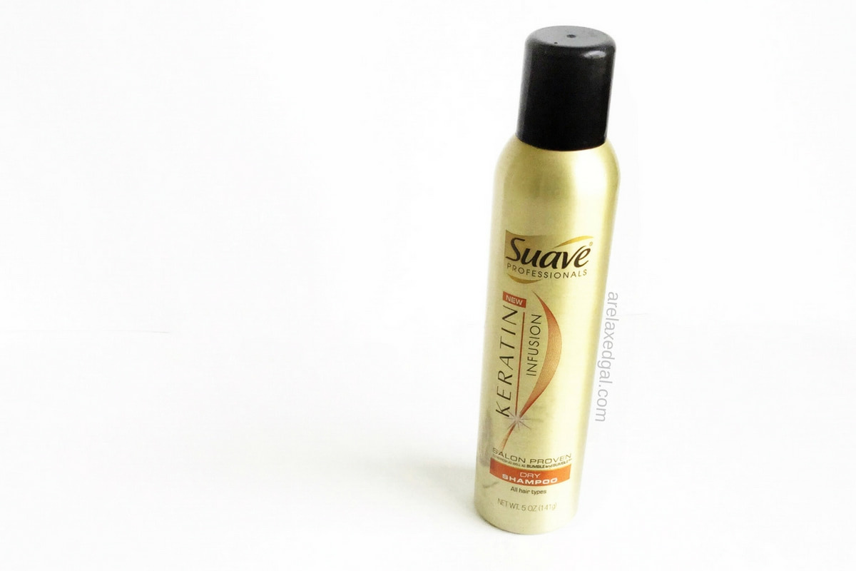 A bottle of the Suave Keratin Infusion Dry shampoo on a white background.