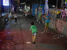 boy jumps out of the way of a paper ball thrown by another boy in Zhuhai, China
