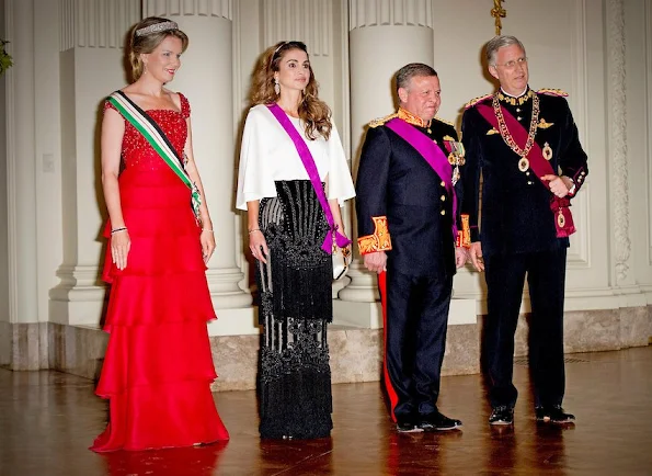 Queen Mathilde and Queen Rania attends a gala dinner at the Laeken royal Palace in Brussels. Queen Rania wore Valentino Gown, Queen Mathilde wore red gown. Queen Mathilde Tiara, Queen Rania wore diamond tiara