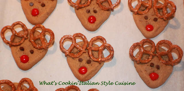 these are peanut butter cookies shaped into a reindeer with pretzel ears, mini chocolate chips for the eyes and red hot cinnamon candy for the nose. A festive Christmas cookie