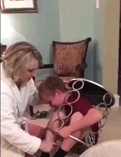 stupid kid stuck in a chair laughing at dumb kid stuck in a footstool