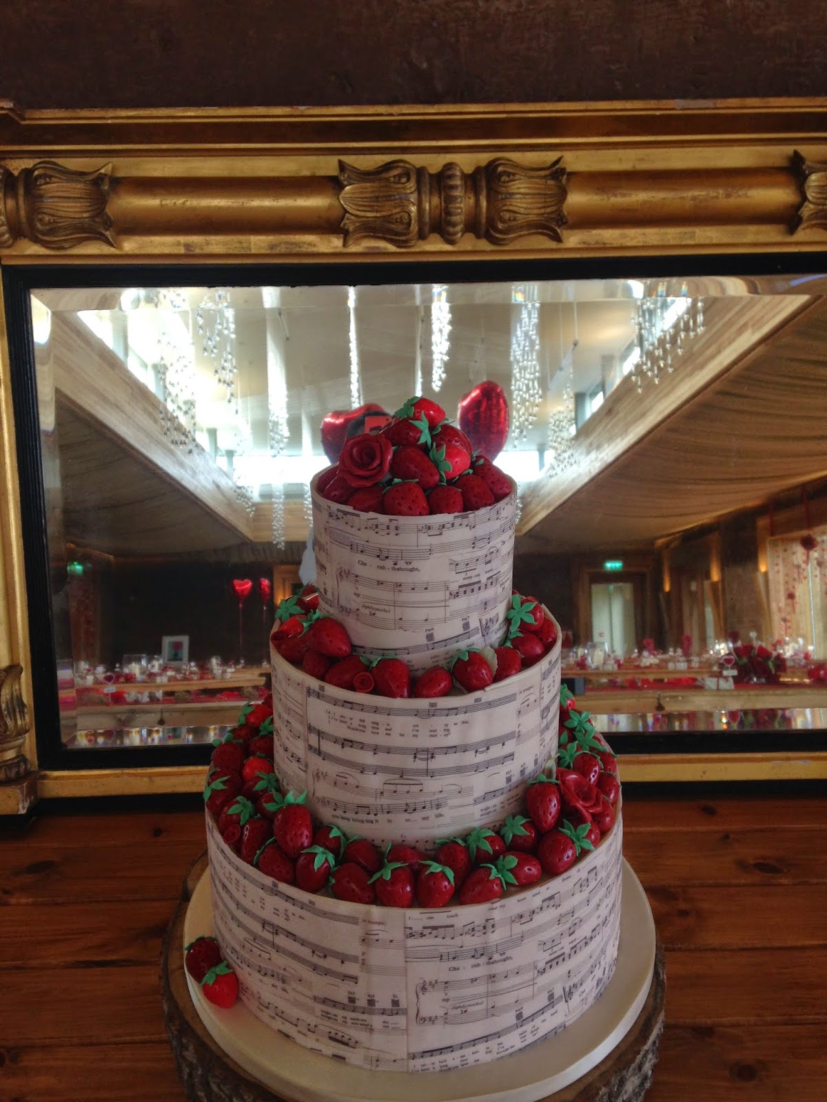 Music sheet and sugarpaste strawberries three tier wedding cake