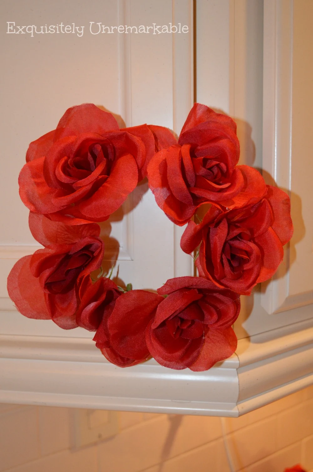 Easy Floral Ring hanging from white kitchen cabinet