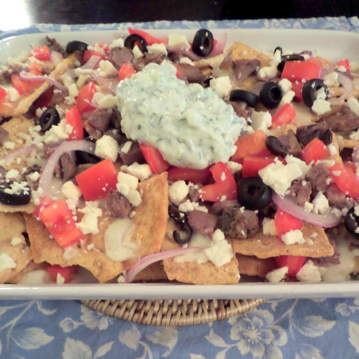 Greek Nachos:  Nachos with a Greek twist.  Pita chips topped with lamb, olives, tomatoes, and feta.