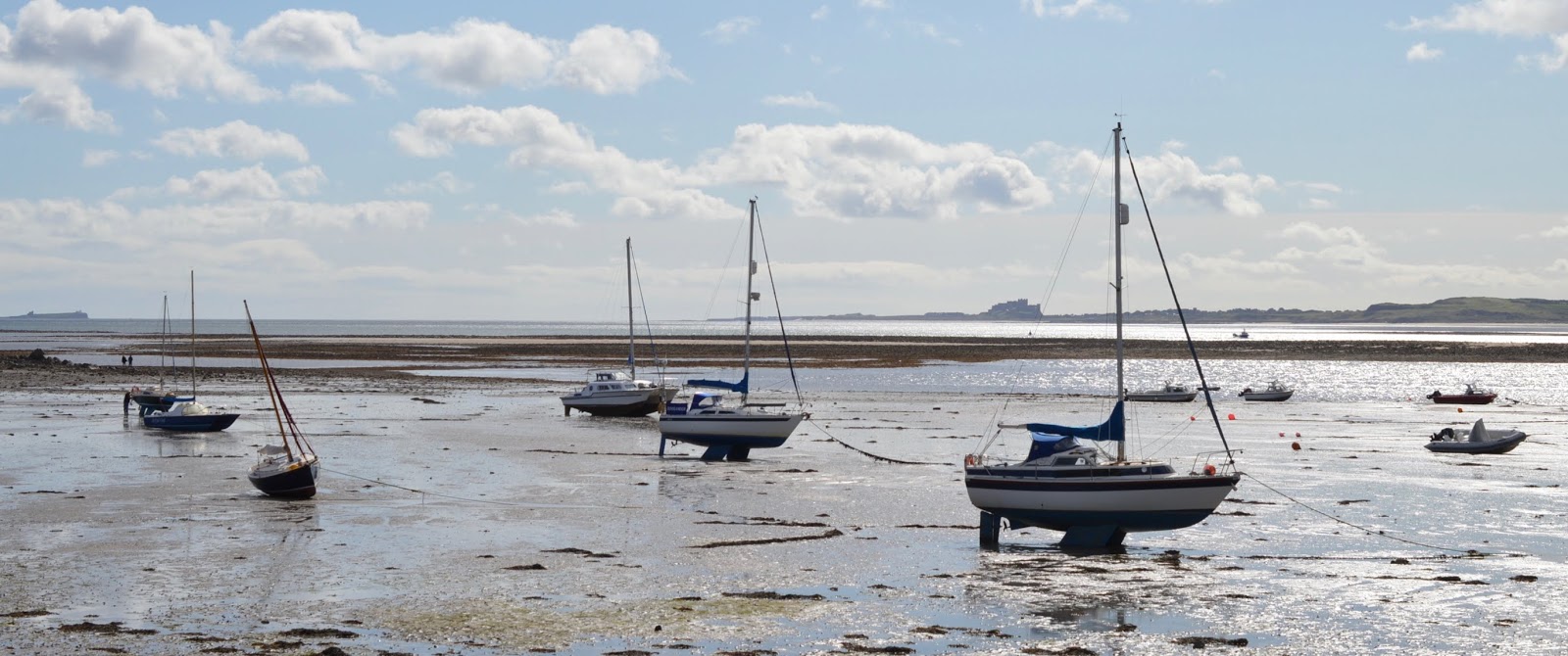 The Holy Island of Lindisfarne, Northumberland - what to see and do during a half day visit - view across harbour to bamburgh castle 
