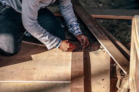 Man measure piece of wood, working, building