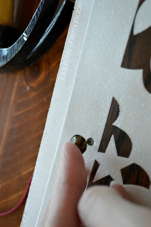 Adding a tack to a wooden board