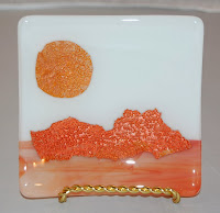 small plate with mica sun and mountains