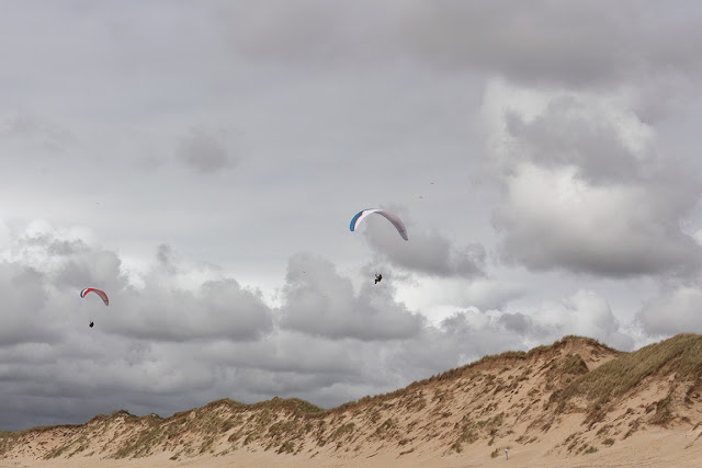 sand dunes, amazing sky and two kite flyers