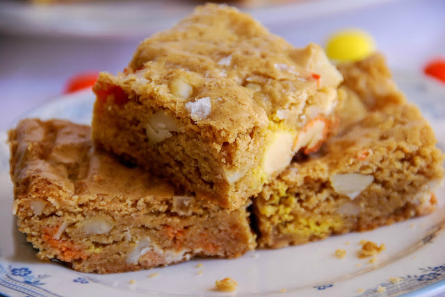 close up of candy corn M&M, roasted macadamia nut, and sea salt blondies on a small plate