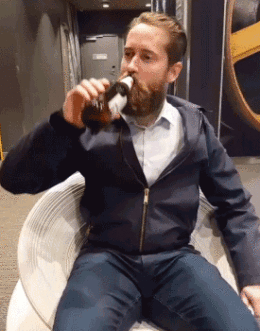 Mann trinkt Bier im Drehstuhl