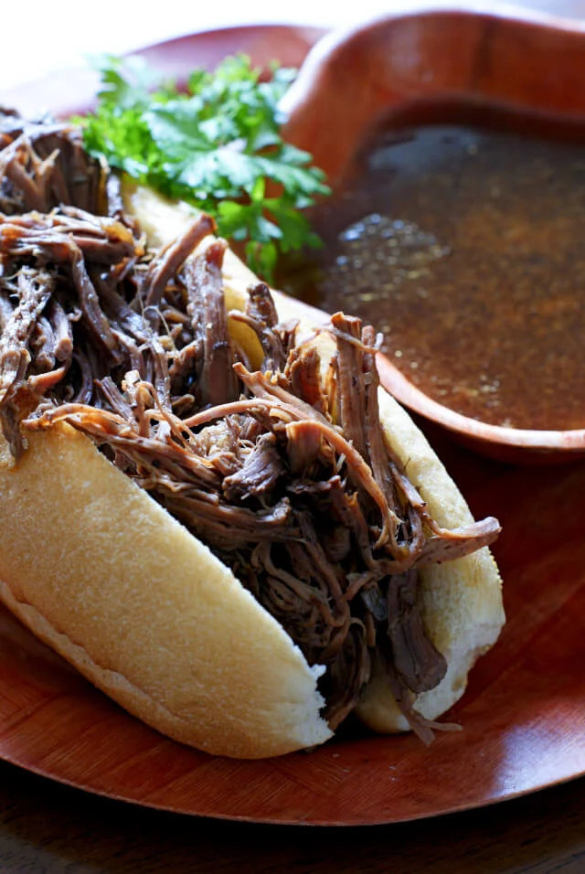 Crock Pot French Dips are super easy to make shredded beef sandwiches served alongside a rich au jus for dipping. #dinner #crockpot #frenchdip