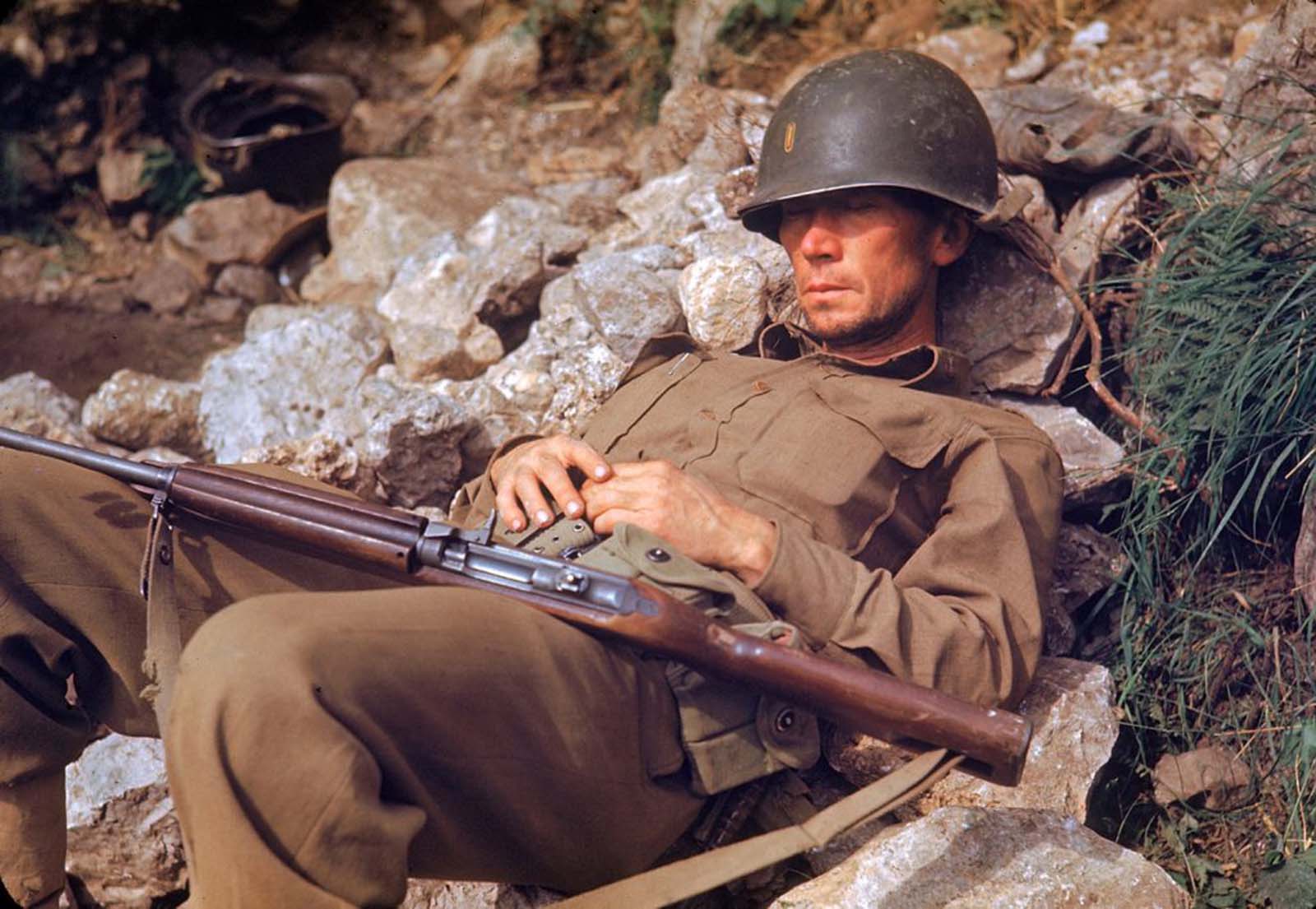 An American soldier slept on a pile of rocks during the drive towards Rome, 1944.