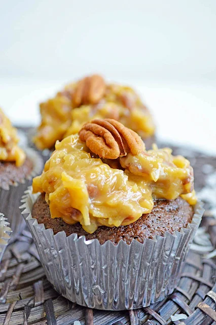 The cupcake is made with Baker's German Sweet Chocolate Bar that gives the true German Chocolate flavor.  Homemade buttery pecan coconut frosting is piled on top to complete the Iconic German Chocolate Cake that is loved throughout the holidays.