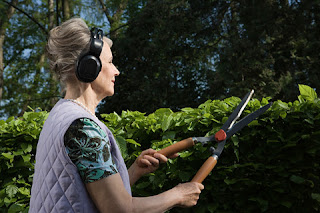 woman gardening headphones listening