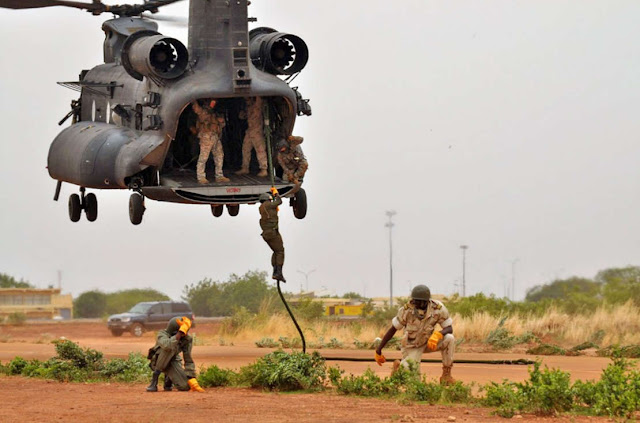 A 160th SOAR MH-47 crew trains local soldiers how to fast-rope.