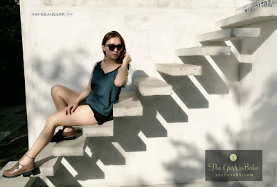 Stepheny Siew the Yesnobabe blogger wearing the Retro Singlet with Lace from Collinstreet.co and her favourite sunglasses sitting on the staircase looking to her left in APWBangsar cafe's garden