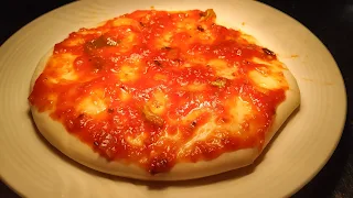 Pizza Sauce spread on pizza base for Margherita pizza Recipe