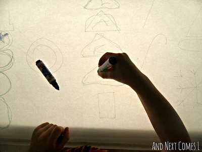 Tracing Christmas shapes and writing letters on the light table from And Next Comes L