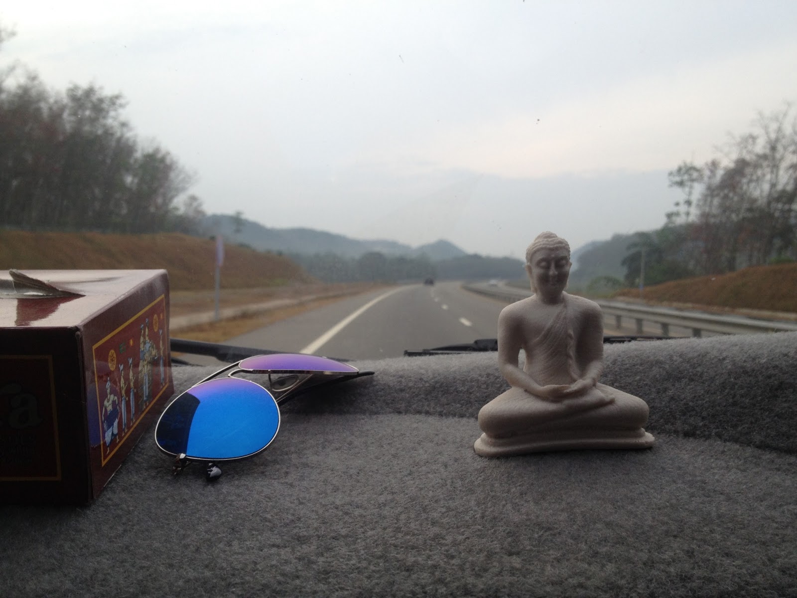 Beauty of the nature Buddha statue on a car dashboard