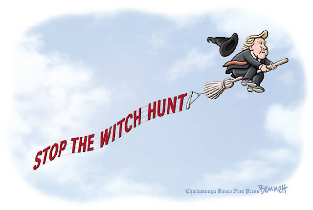 Donald Trump flying through the air riding a broom and trailed by a witch's hat towing a banner that says