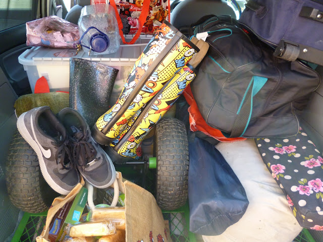 camping equipment stacked in a car