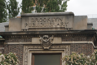 Foliated stone and building name in stone above entrance