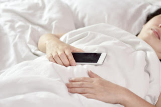 woman asleep holding phone