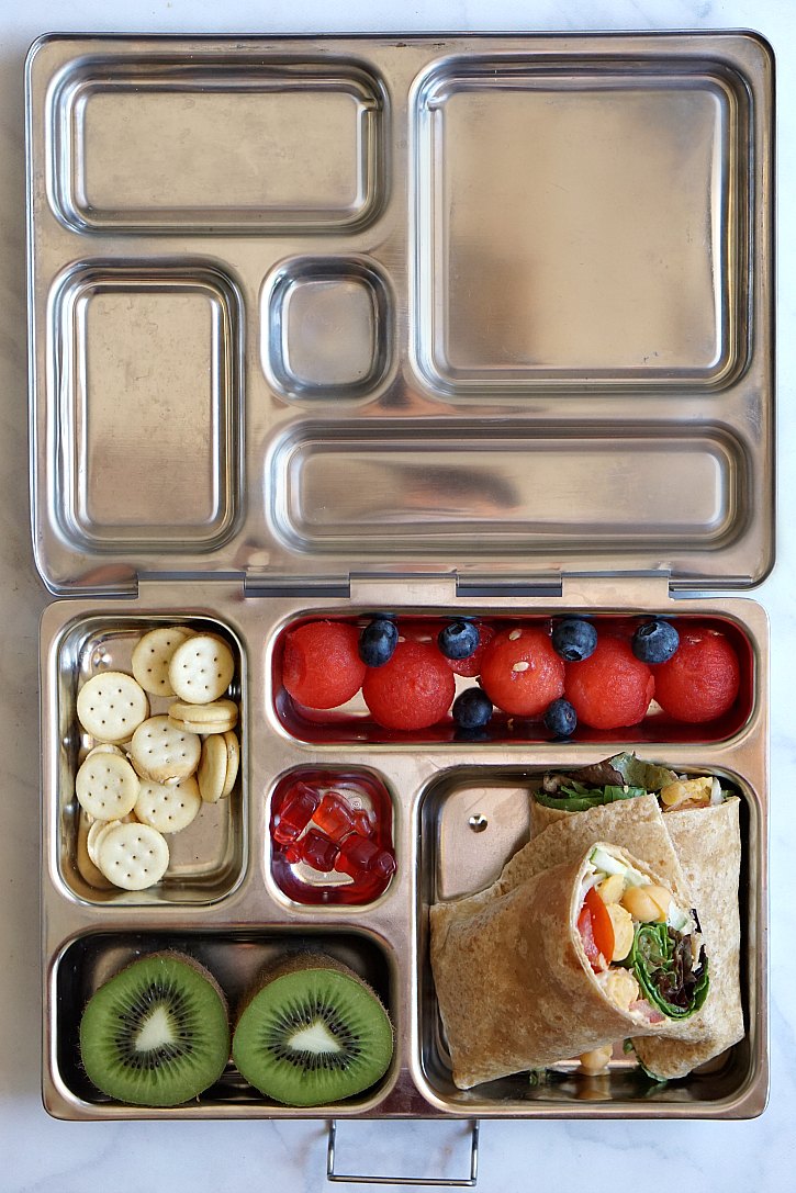 Mediterranean hummus wrap Vegetarian packed lunch with a Mediterranean wrap.