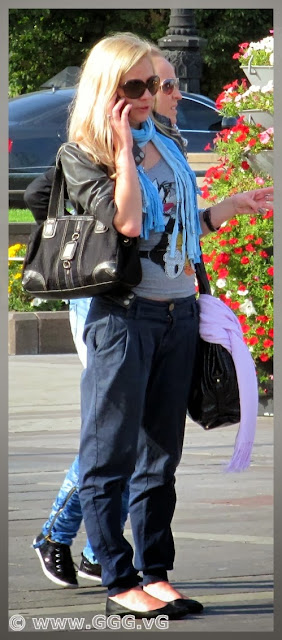 Blonde girl wears sunglasses on the street