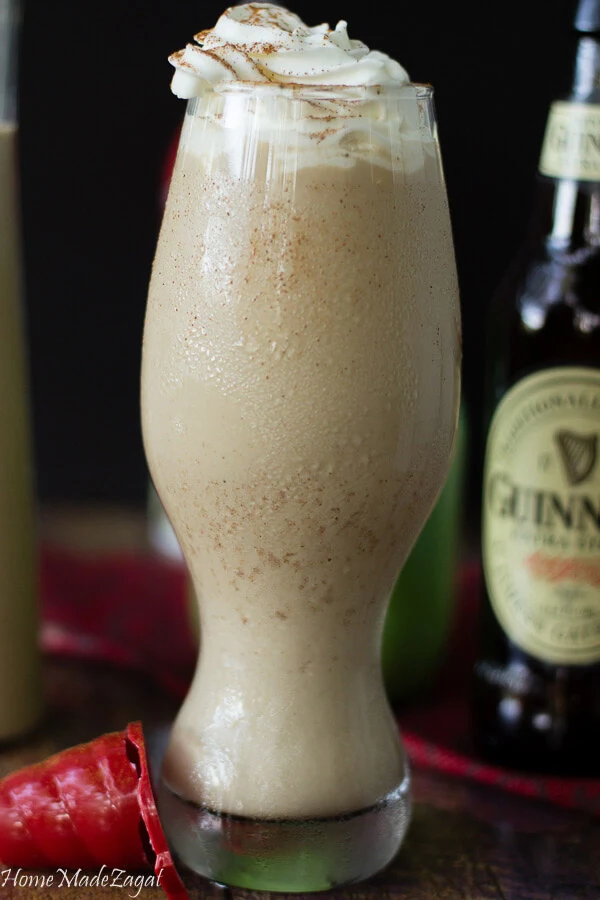 A tall serving of chilled Guinness stout punch with some whipped creme.