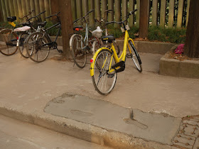 bike parked in a perfect location to guide people into walking on the wet concrete