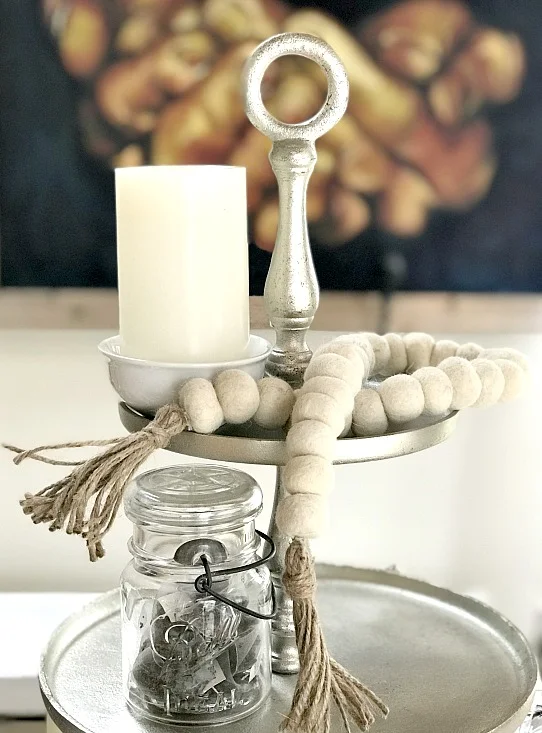 tiered tray with candle and felted garland