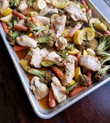 Garden fresh vegetables and chicken bathed in honey garlic goodness and cooked simply on a sheet pan. Get your rice cooking, dinner will be ready soon! sheet pan of honey garlic chicken and veggies fresh from oven