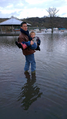 Man and boy in flooded river