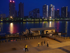woman exercising at night next to the Xiang River in Hengyang