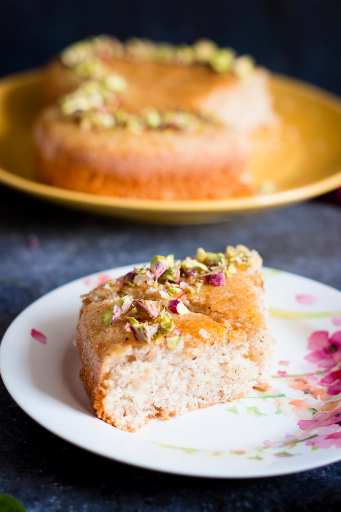 Persian love cake is an eggless rose and cardamom flavored cake made with almond flour and semolina. Brushed with an orange syrup and topped with chopped nuts.