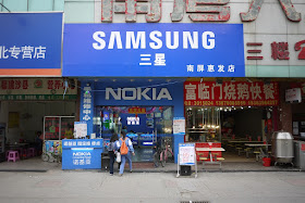 store with many Nokia signs with a larger Samsung sign at the top
