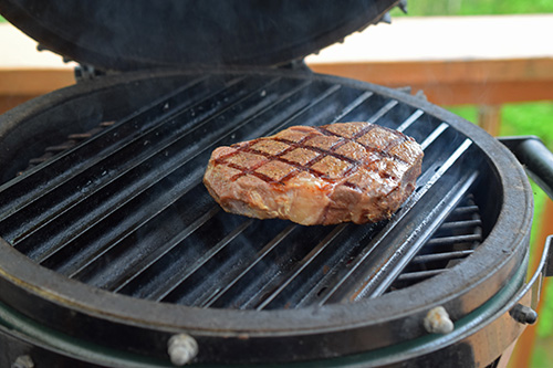 Dry aged Certified Angus Beef Brand ribeye steak on a small kamado grill with GrillGrates