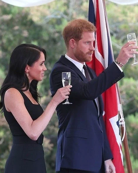 Meghan Markle wore a bespoke black sleeveless dress by Emilia Wickstead, and Deneuve shoes by Aquazzura. She carried a black satin clutch by Givenchy