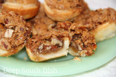 Little bite sized pecan desserts, made with a cream cheese pastry crust baked with a brown sugar based pecan filling.