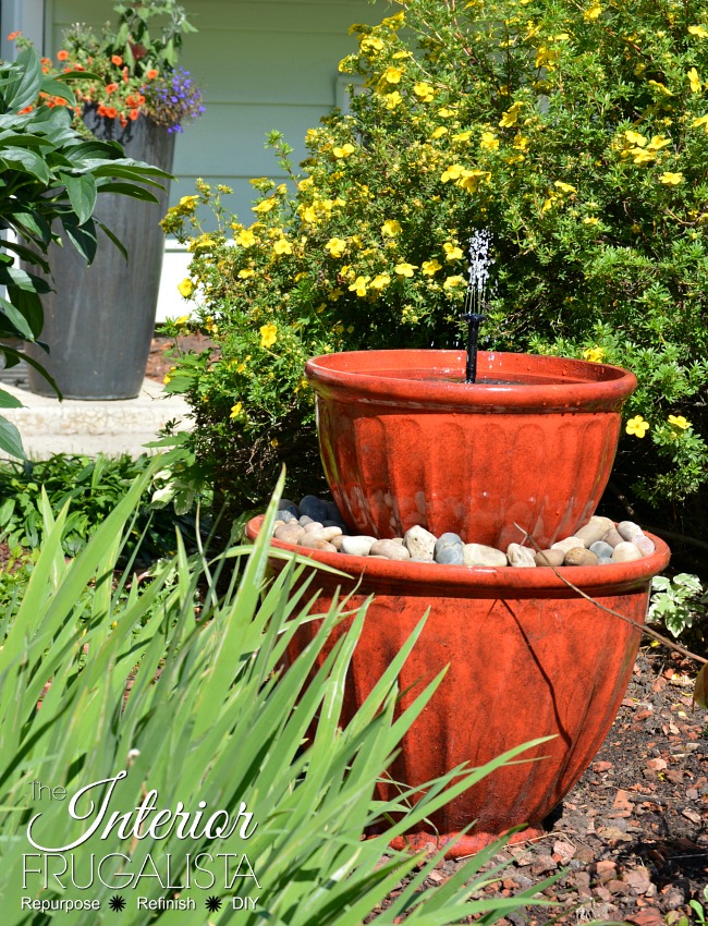 How to make a backyard solar plant pot water fountain in under fifteen minutes with stacked flower pots perfect for a deck, patio, porch, or balcony.