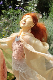 Birth Dance sculpture by Corina Duyn. Detail of the young girl in a summer garden 