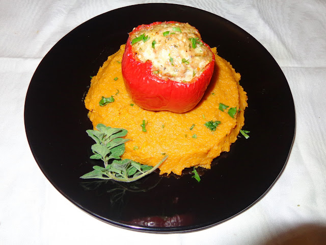 PORTIONS: 4 INGREDIENTS FOR STUFFED PEPPERS WITH CHICKEN 4 medium size red bell peppers. Sliced off the top and seeded 1 lb. ground chicken ½ diced onion 2 tbsp.  Small diced carrots 2 tbsp. Small diced celery 1 minced garlic clove  ½ tbsp. chopped parsley 1 tsp. chopped fresh oregano 1½ tsp. salt ½ tsp. ground pepper 1½ tbsp. bread crumbs METHOD Cut off part of the bottom of the pepper to make it stable. In a bowl mix the chicken with the rest of the ingredients. Stuff the peppers with the chicken mix and place it in a baking dish. Preheat the oven at 375°F.  Cook until the center of the pepper reaches a minimum temperature of 165° F. SWEET POTATO PUREE 3 peeled sweet potatoes 1 tsp. salt ¼ tsp. ground cinnamon 2 tbsp. butter In a pot with water and salt cook the potatoes until soft. Drain the water. Add cinnamon, butter and make a puree. Place the puree in plates and put the stuffed pepper in the center.