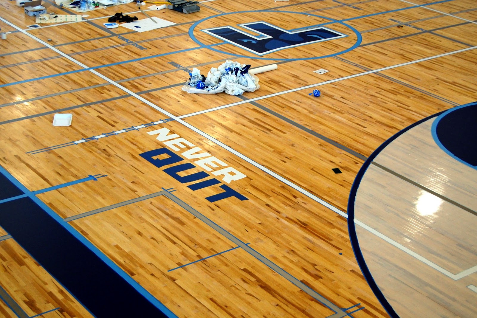 "never quit" written in on the gym floor