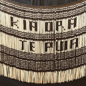 Maori grass skirt with the words 'Kia ora Te Puia' woven into it.
